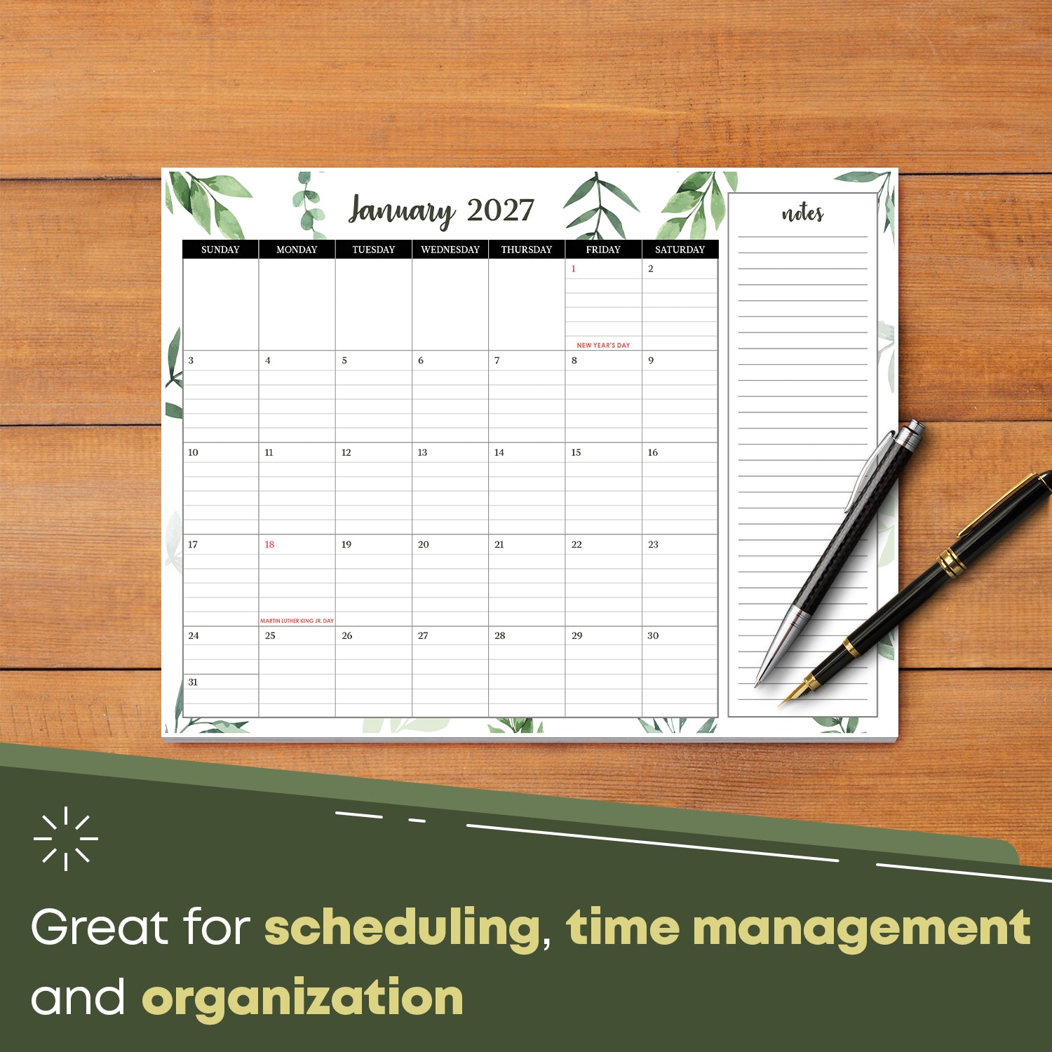 2027 desk calendar on a wooden desk with pens, January page with ruled day boxes
